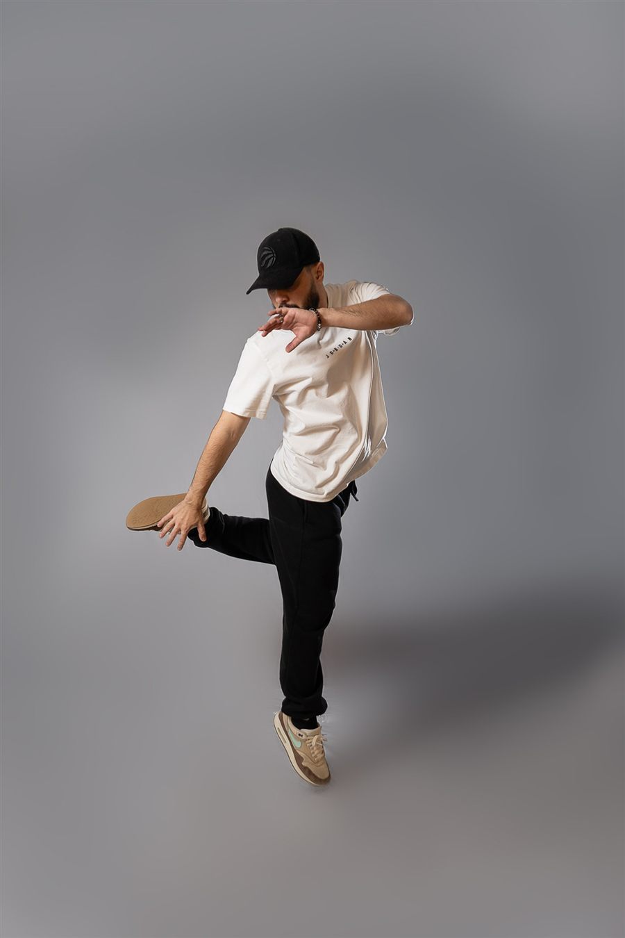 Brasileirada instructor mid-move, kicking one heel up behind